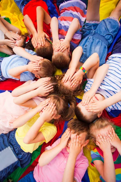 Kids taking a break relaxing on the floor — Stock Photo, Image