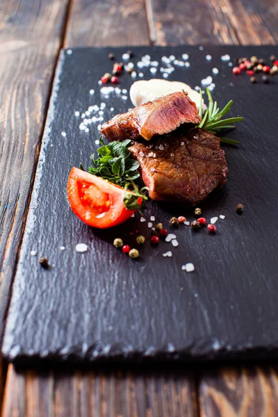 New York steak with vegetables and spices on the wooden table — Stock Photo, Image