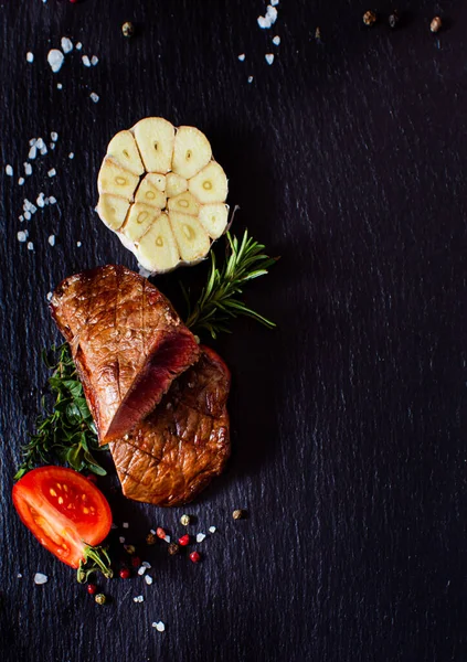 Tasty grilled steak with vegetables and spices — Stock Photo, Image