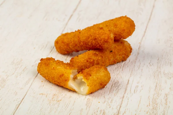 stock image Crispy roasted dinner cheese sticks  on wooden table