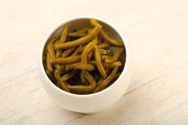 Canned Green beans over wooden background