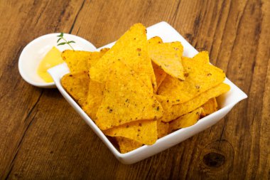 Ahşap masa üzerinde peynir soslu cips