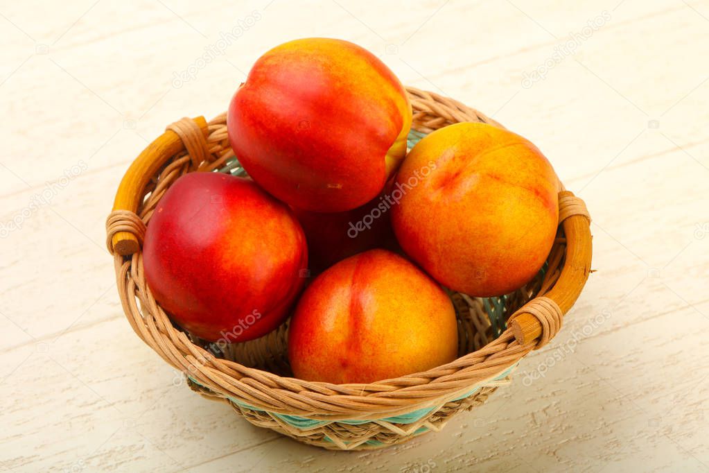 Ripe Nectarines heap over wooden background