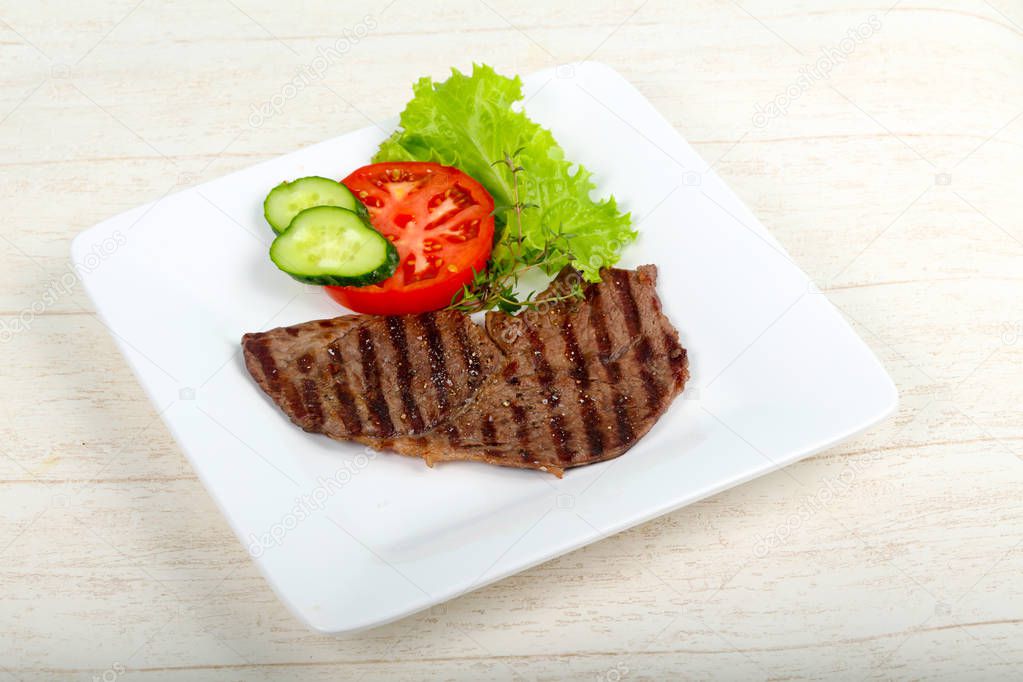 Grilled beef steak with sauce and thyme