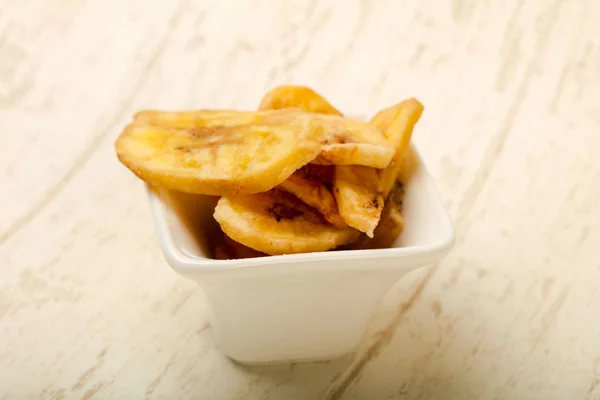 Dry banana chips in white plate