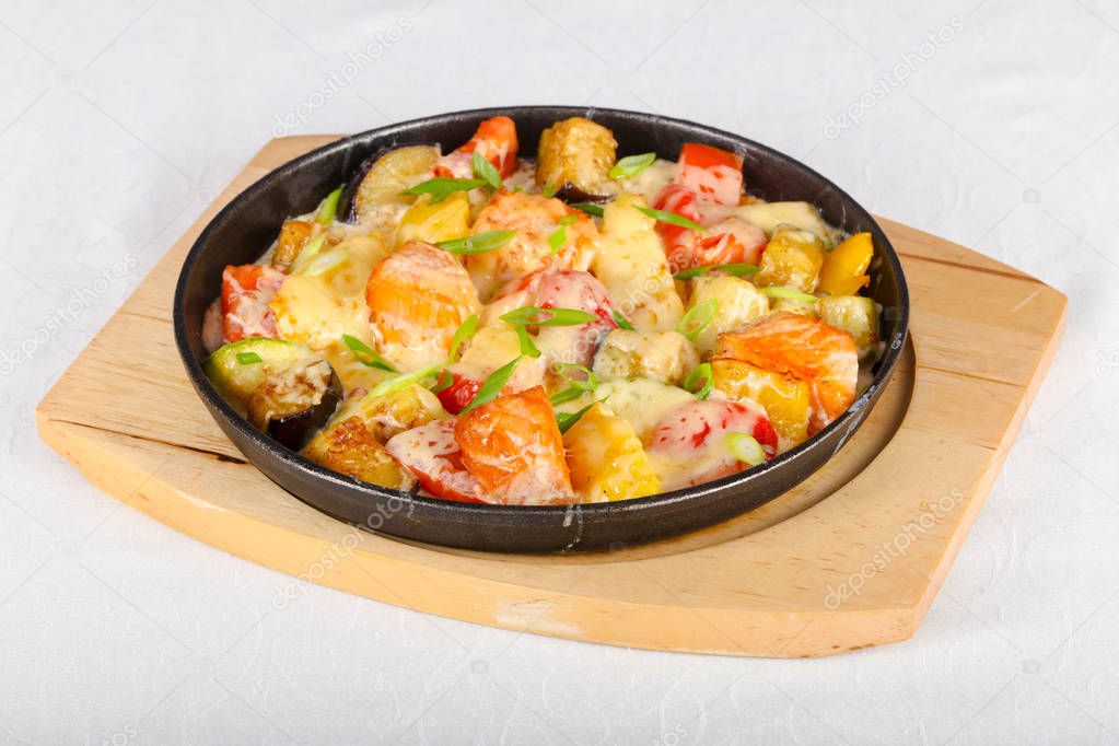 Baked salmon with potato and tomato in pan