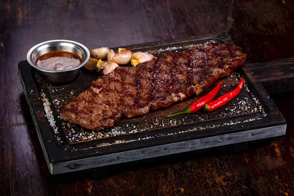 Grilled beef steak with sauce and pepper