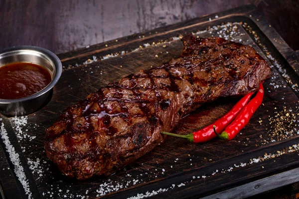 Grilled beef steak with sauce and pepper