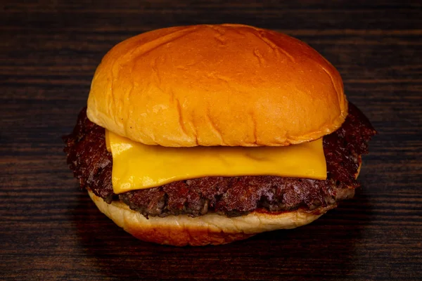 Ahşap arka plan üzerinde lezzetli sıcak burger