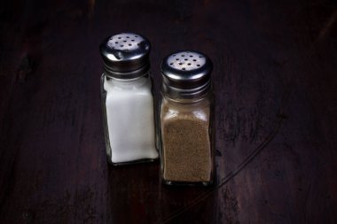 Salt and pepper over wooden background clipart