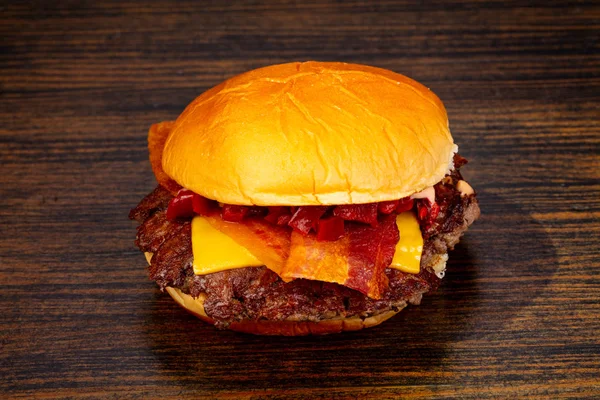 Tasty hot burger over wooden background