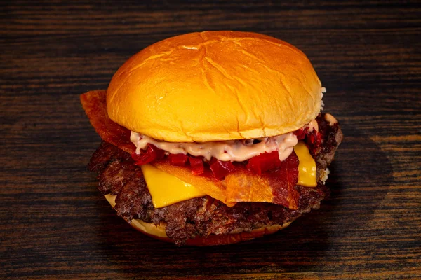 Tasty hot burger over wooden background