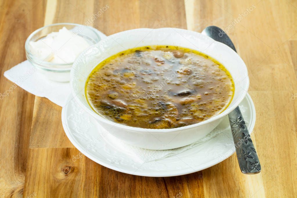 Tasty chestnut soup over wooden background