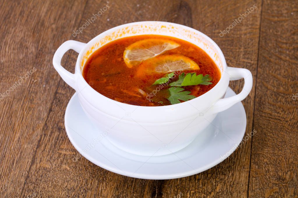 Solyanka soup with lemon serbed parsley