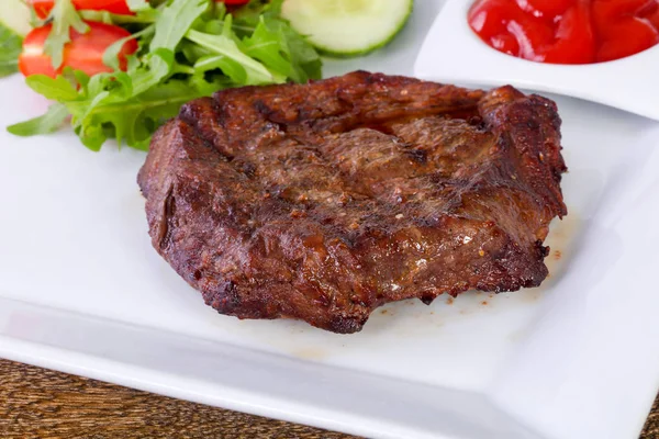 Beef steak with sauce and salad dressing