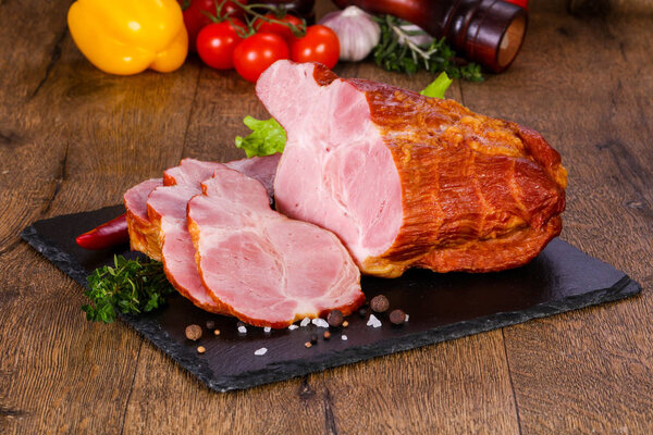 Smoked pork meat over the wooden background