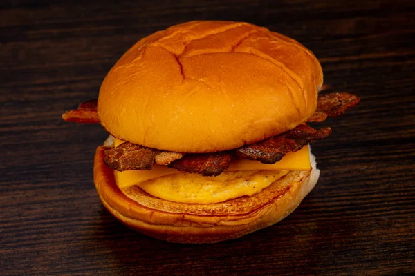 Tasty hot burger over wooden background