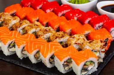 Soslar ve wasabi ile lezzetli California ve Philadelphia suşi