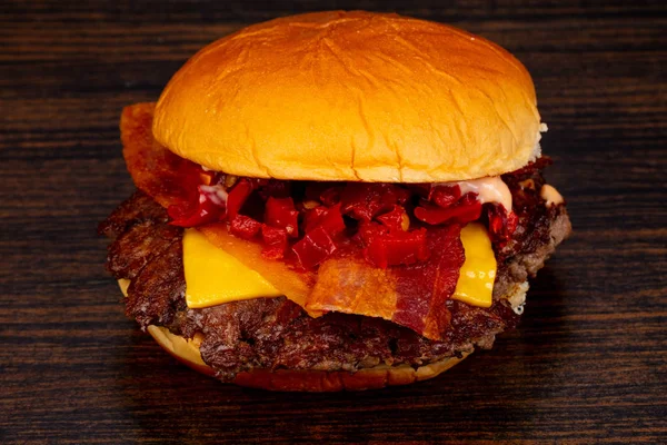 Tasty hot burger over wooden background