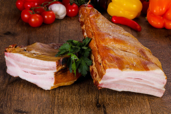 Smoked pork meat over the wooden background