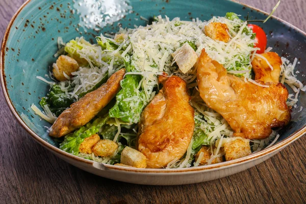 Caesar salad with chicken and parmesan cheese