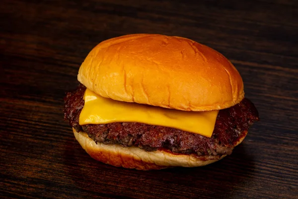 Tasty hot burger over wooden background