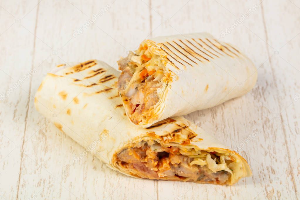 Appetizing big shawarma with meat, sauce and salad