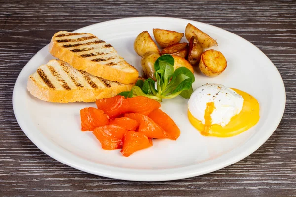 stock image Tasty egg poached with salmon and potatoes