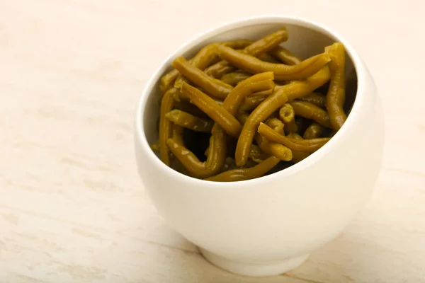 Canned Green beans in bowl on white table