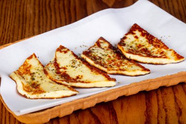 Grilled halloumi cheese with spices clipart