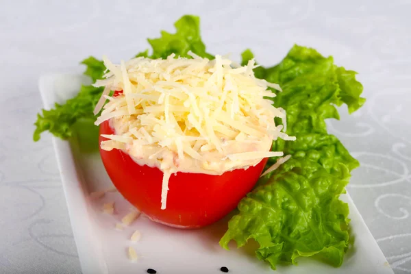 Stuffed tomato with cheese and garlic sauce