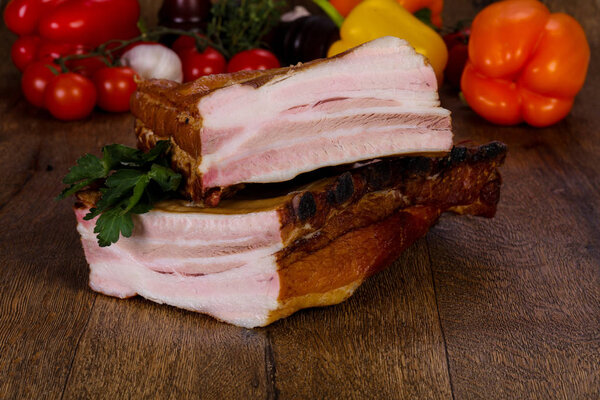 Smoked pork meat over the wooden background