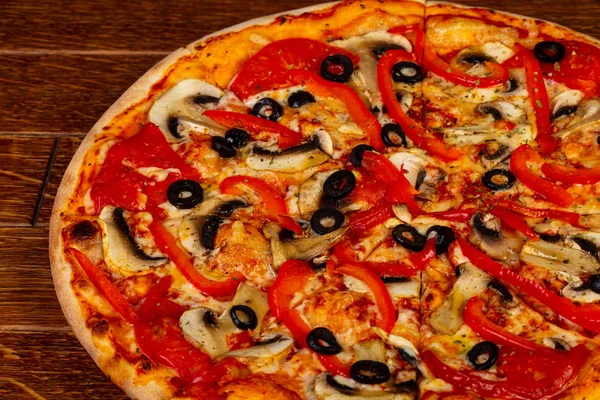 Vegetarian pizza with mushroom, pepper and tomato