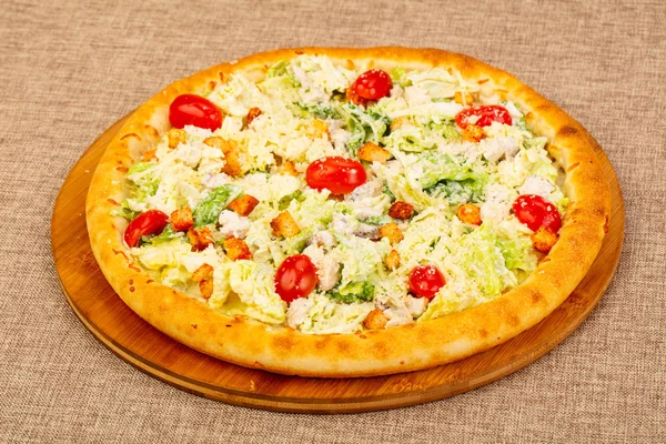 Pizza with chicken and salad leaves