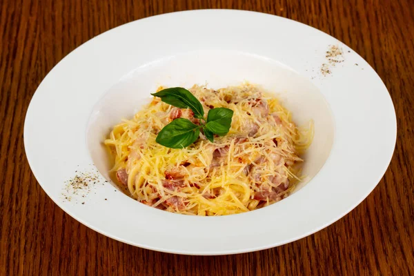 Makarna spagetti Carbonara fesleğen yaprakları servis