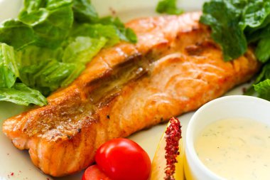 Izgara somon steak sos ve salata yaprakları ile