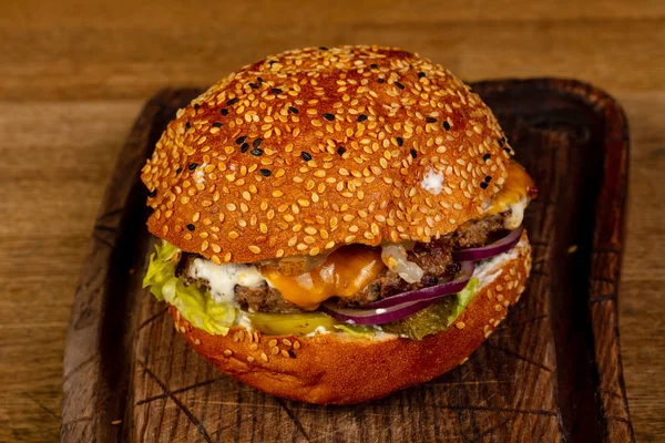 Tasty burger with meat and cheese