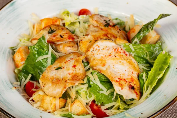 Caesar salad with chicken and parmesan cheese