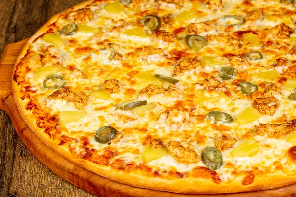 Pizza with pineapple, cheese and chicken