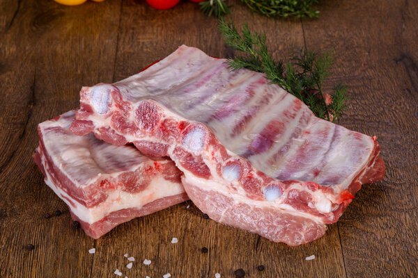 Raw pork meat over wooden background