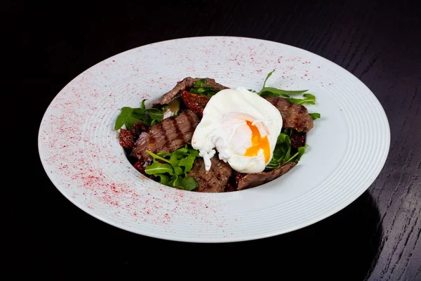 Tasty beef cut salad with poached egg