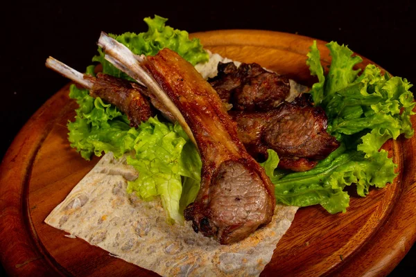 Grilled rack of lamb served salad leaves