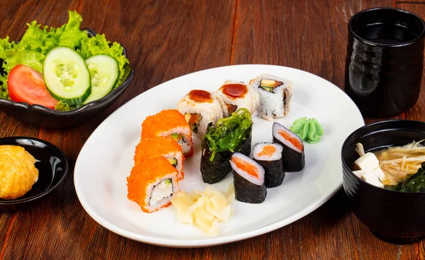 Japanese sushi and roll set with salad and miso soup