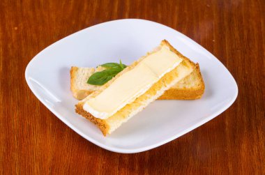 Oturup ahşap arka plan üzerinde brie peyniri ile