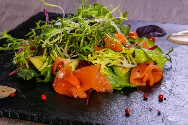 Salad with salmon and avocado with nut sauce
