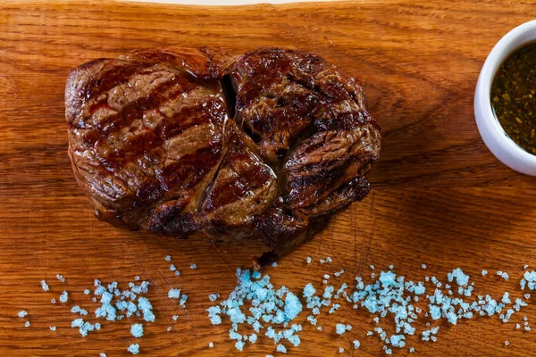 Grilled beef steak with sauce and blue salt