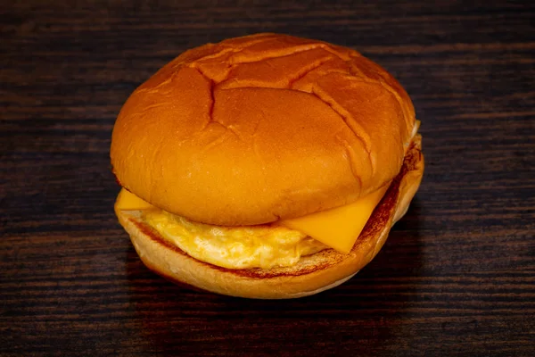 Tasty hot burger over wooden background