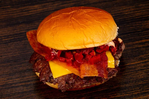 Tasty hot burger over wooden background