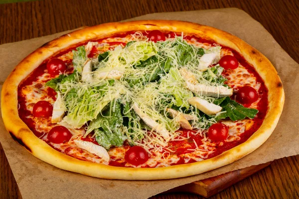 Pizza Caesar with chicken and salad leaves