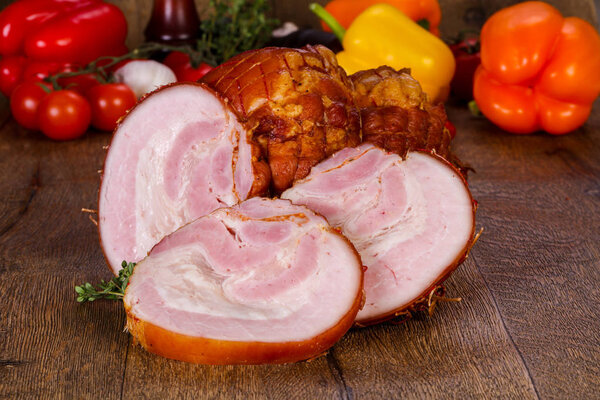 Smoked pork meat over the wooden background